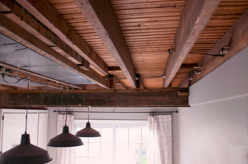 Removing drywall, plaster, and lath ceilings under a drop ceiling to reveal industrial exposed rafters and beams