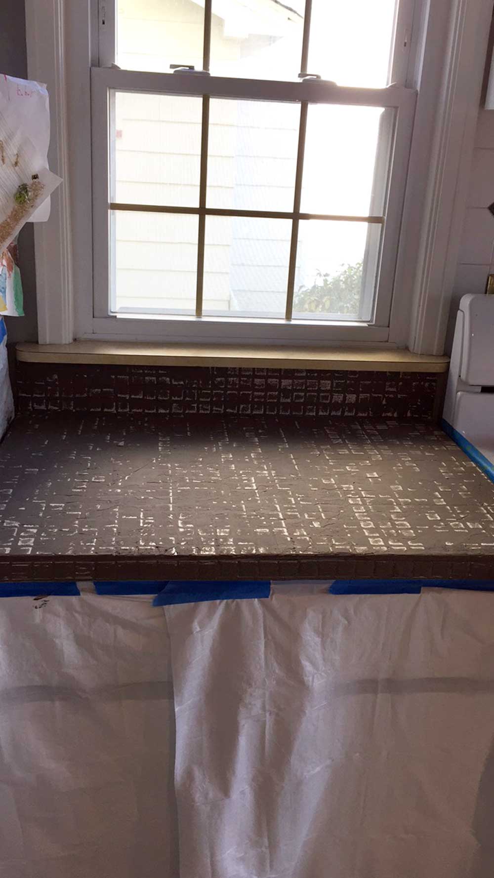 First coat of feather finish concrete over tile counters