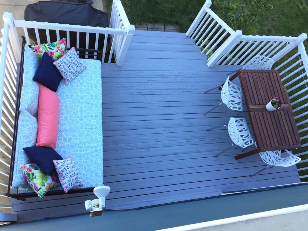 Refinished back deck layout with a daybed and a dining table