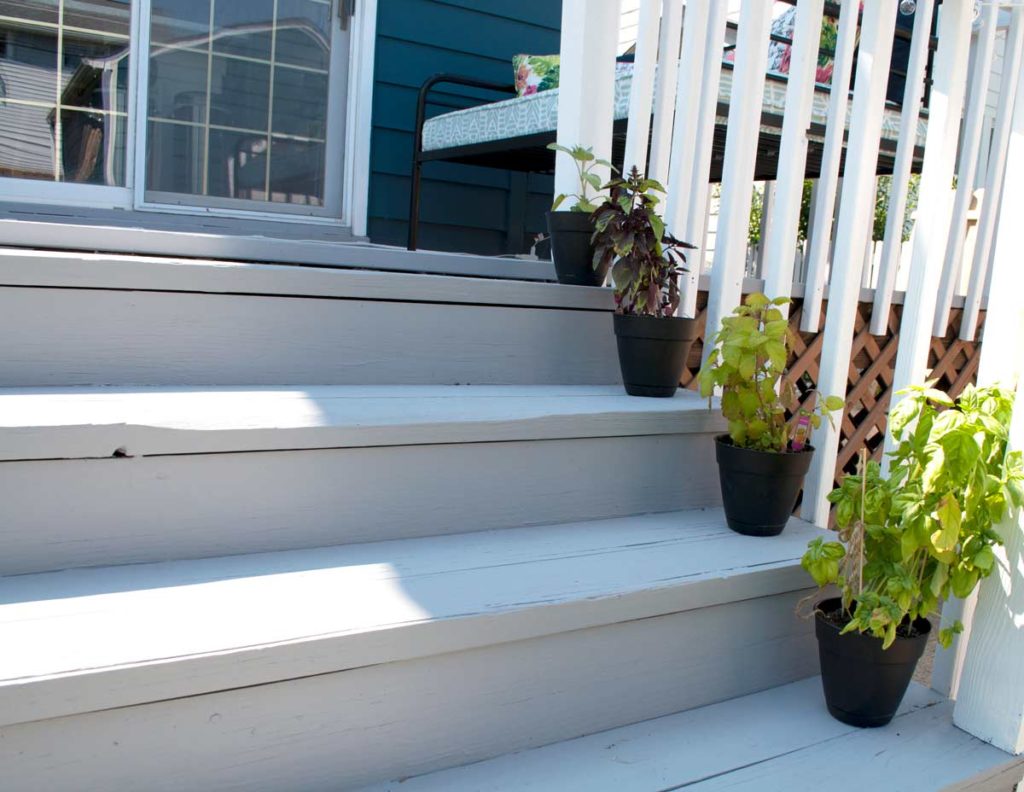 Growing herbs on deck steps 