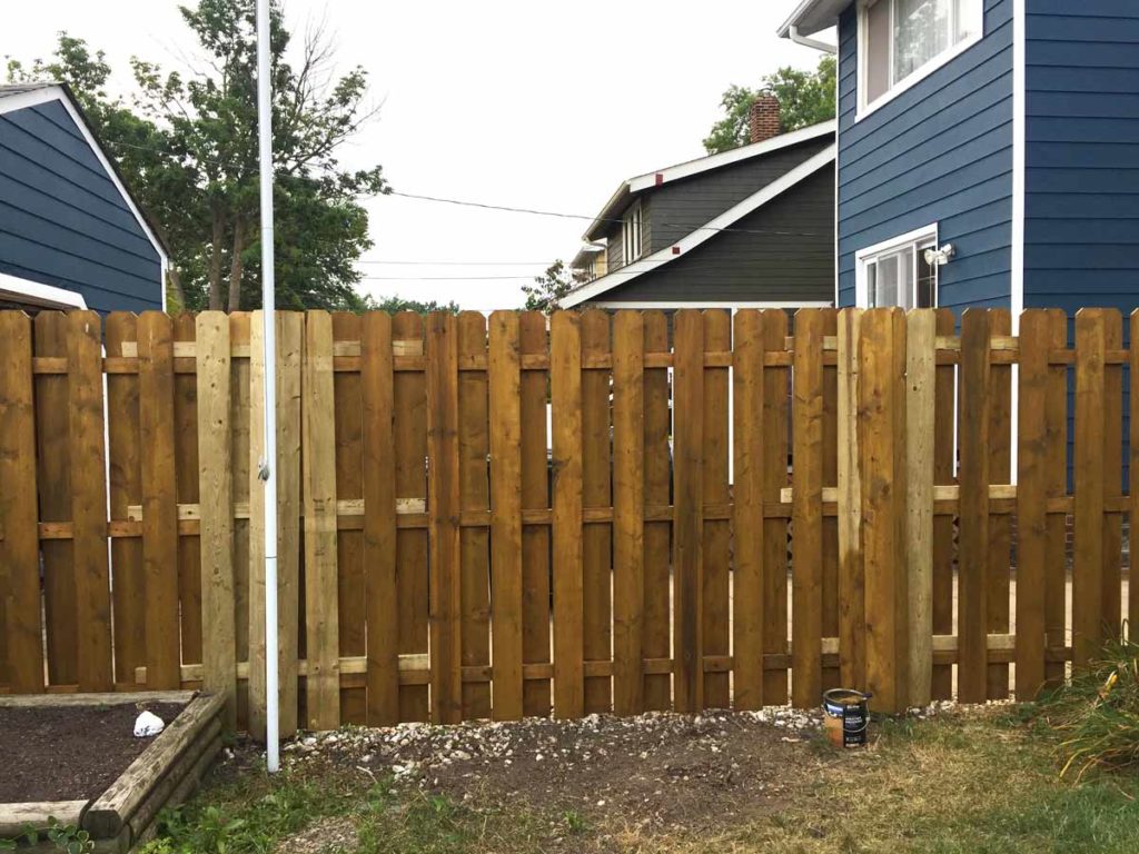 cover the steel posts with extra pickets when converting a chainlink fence to a wood fence