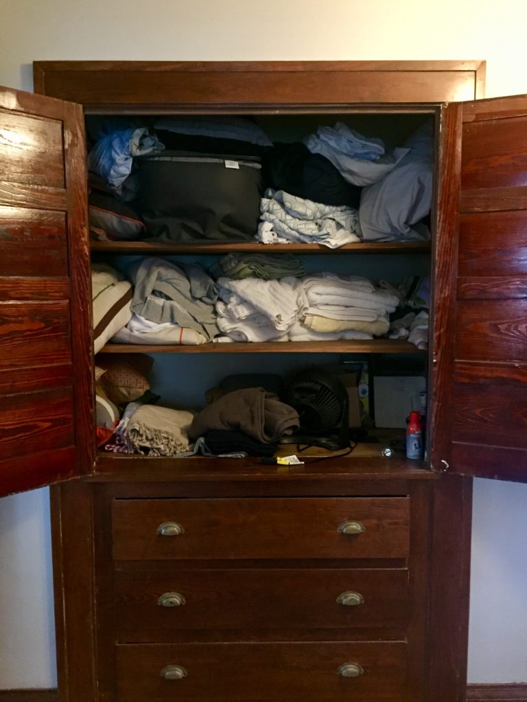 DIY linen closet organization before